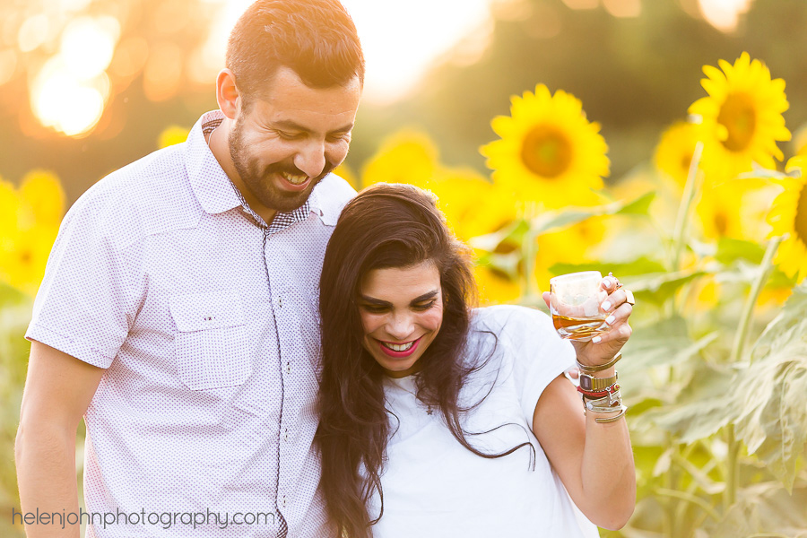Couple drinking together during afternoon engagement session