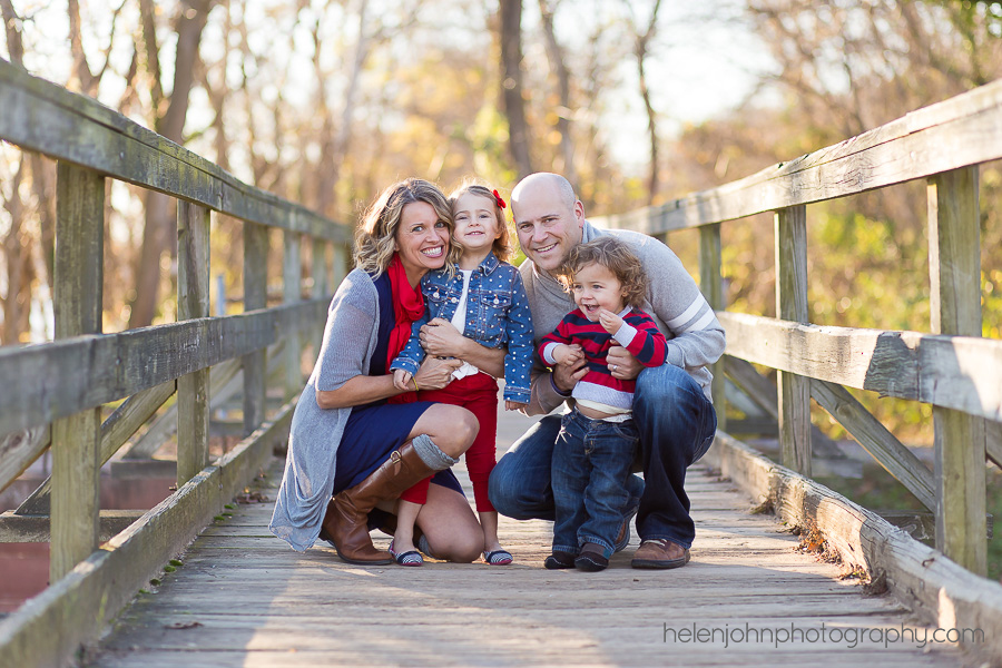Portrait of a mom, dad, daughter, and son on a bridge, taken during family portraits