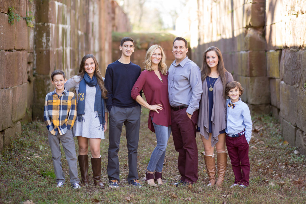 family of seven wearing fall colors 