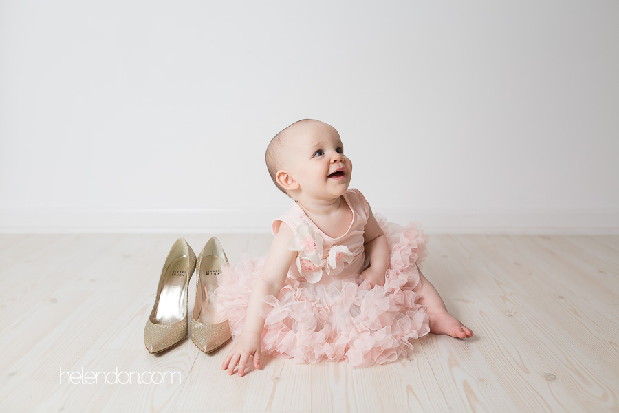 one year old girl with moms gold high heels