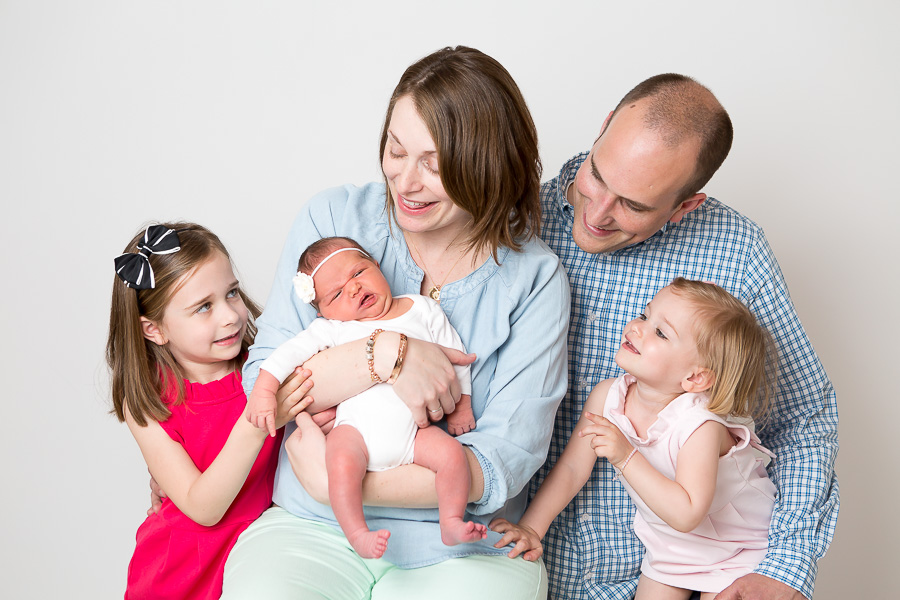 newborn funny face with family