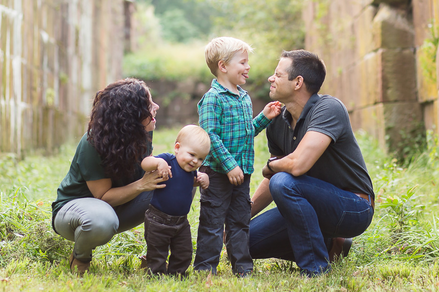 boys sticking tongue out at dad