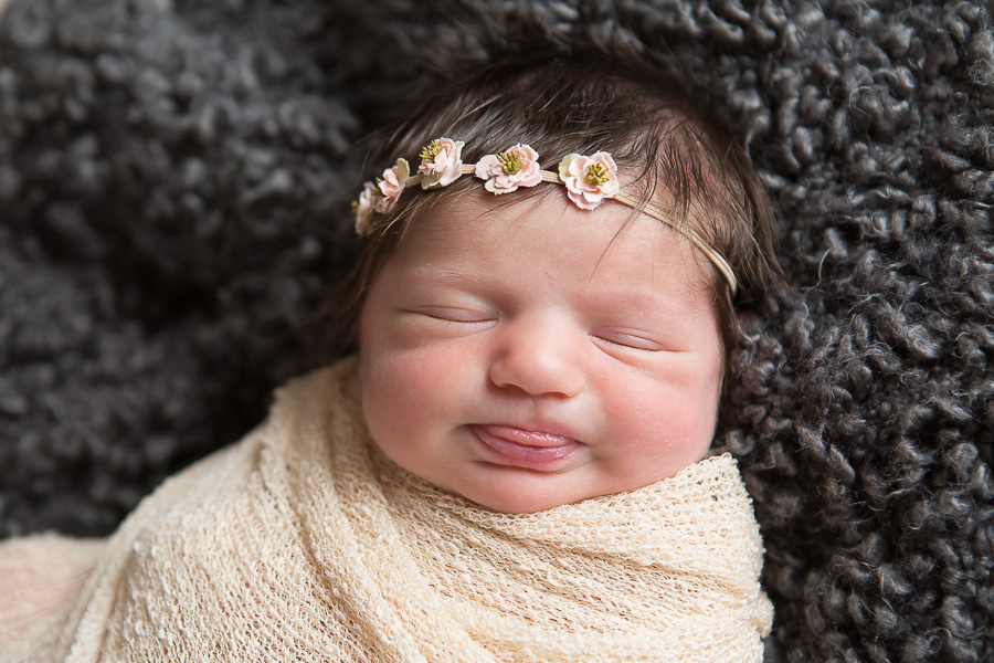 newborn girl sticking tongue out