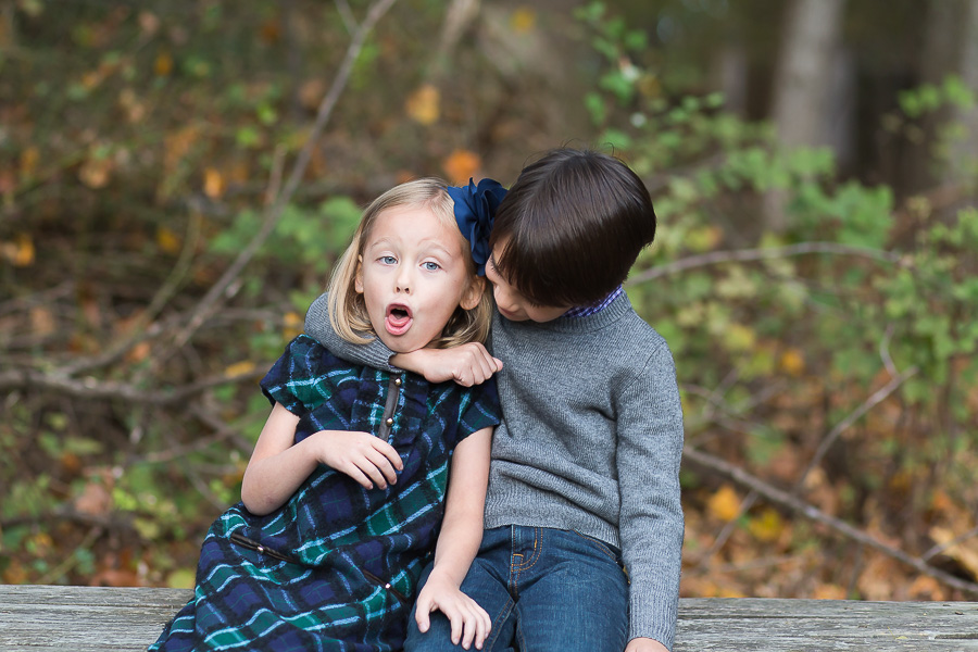 big brother squeezing baby sister