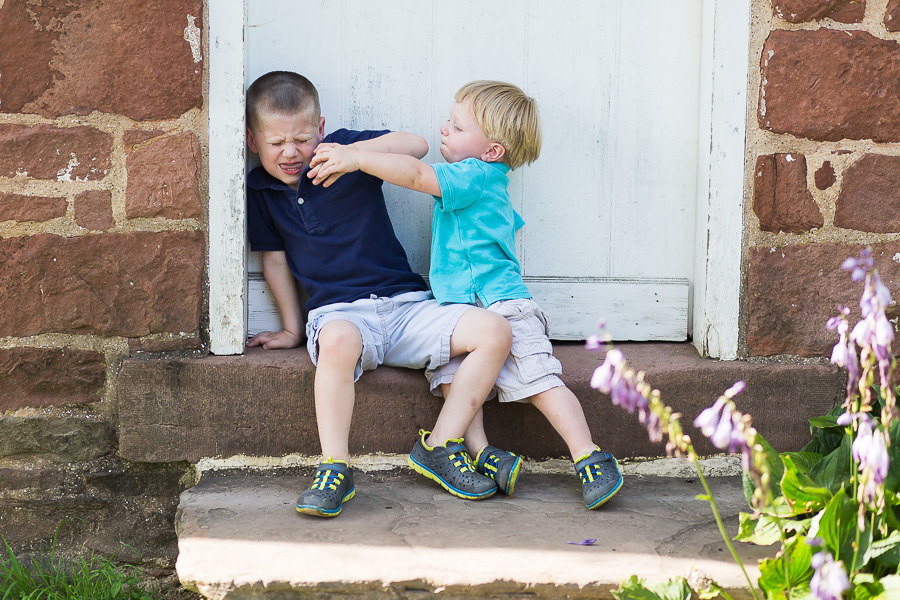 baby brother punching big brother