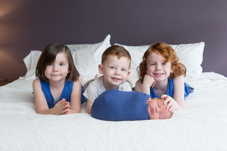 three older siblings with newborn brother