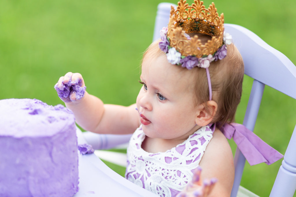 baby eating purple cake