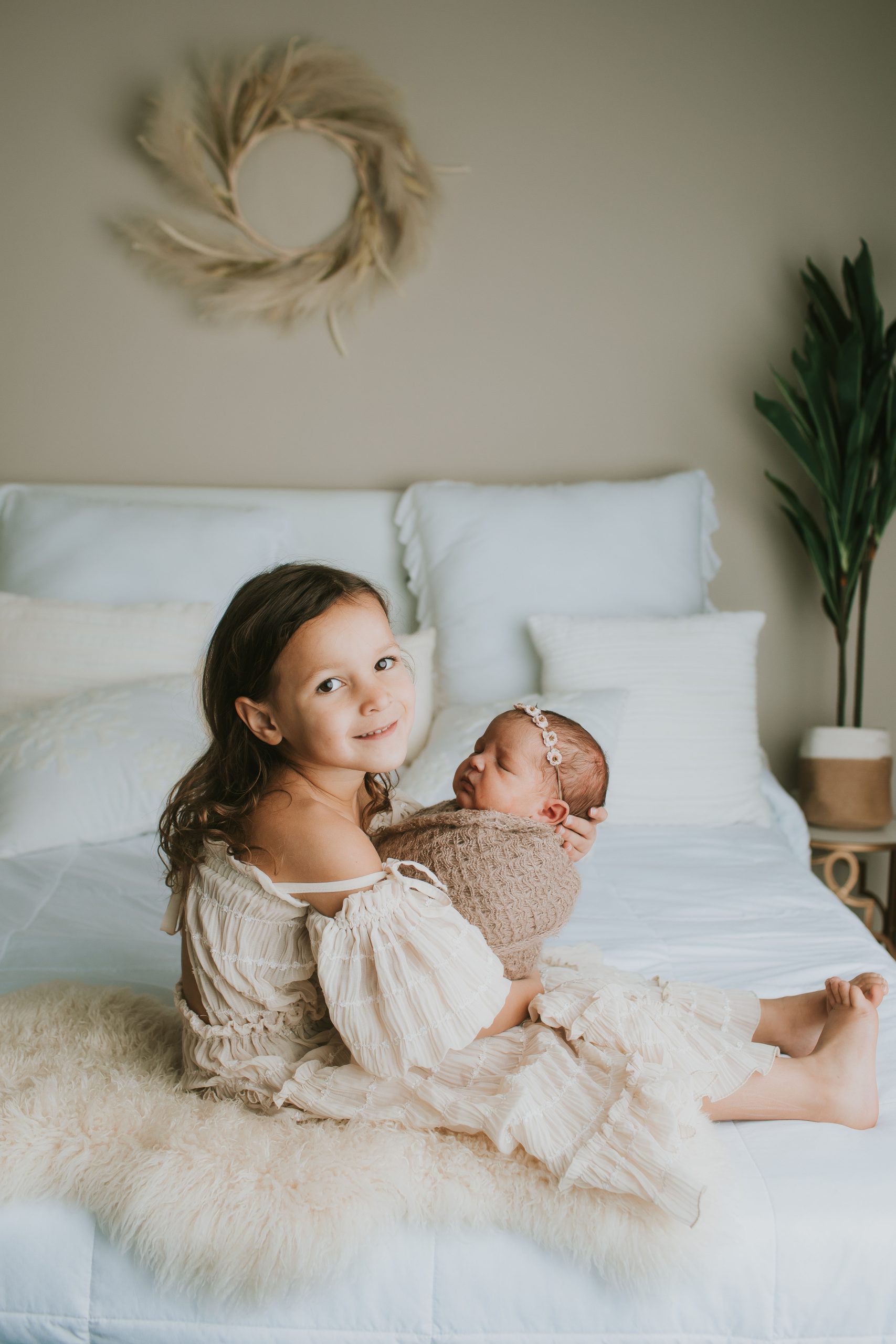 four year old sister holding nb sister