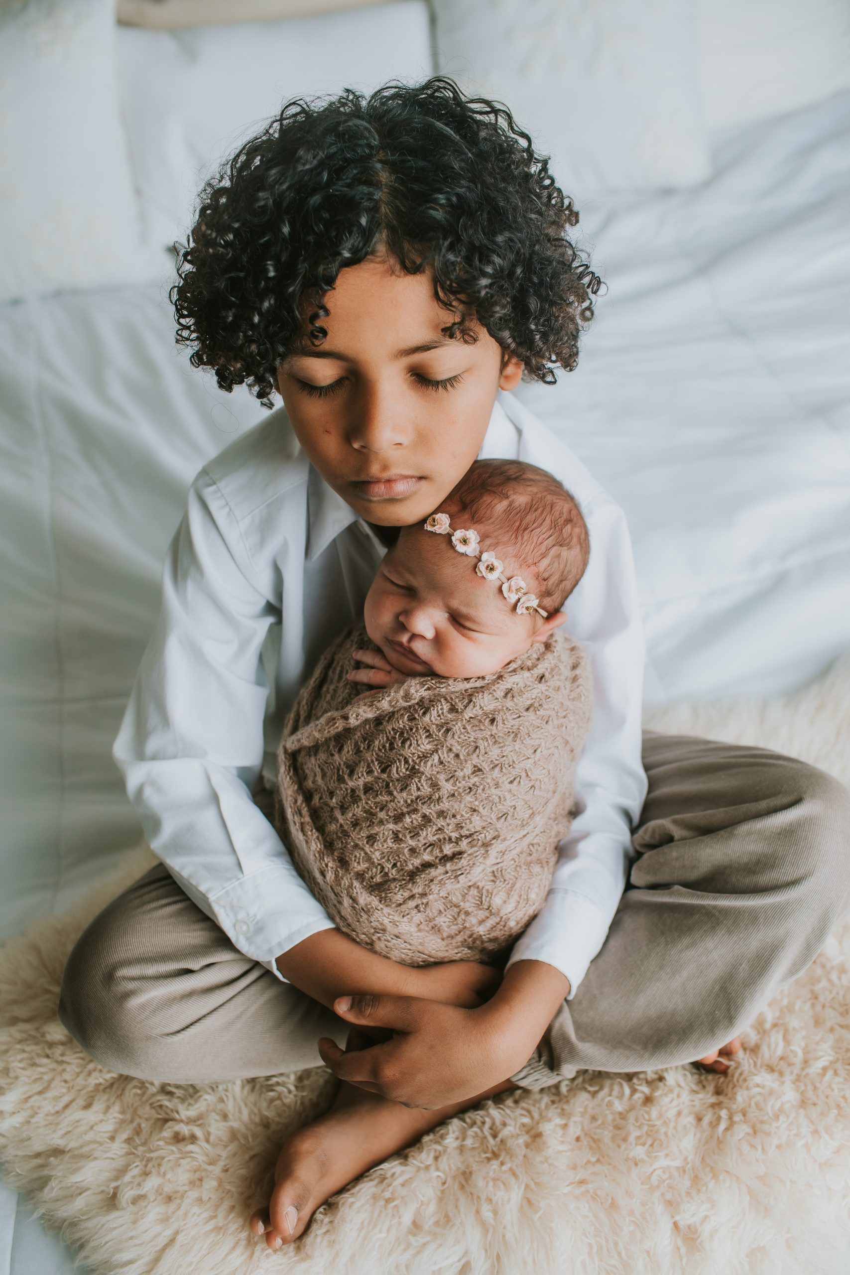 big brother holding baby sister