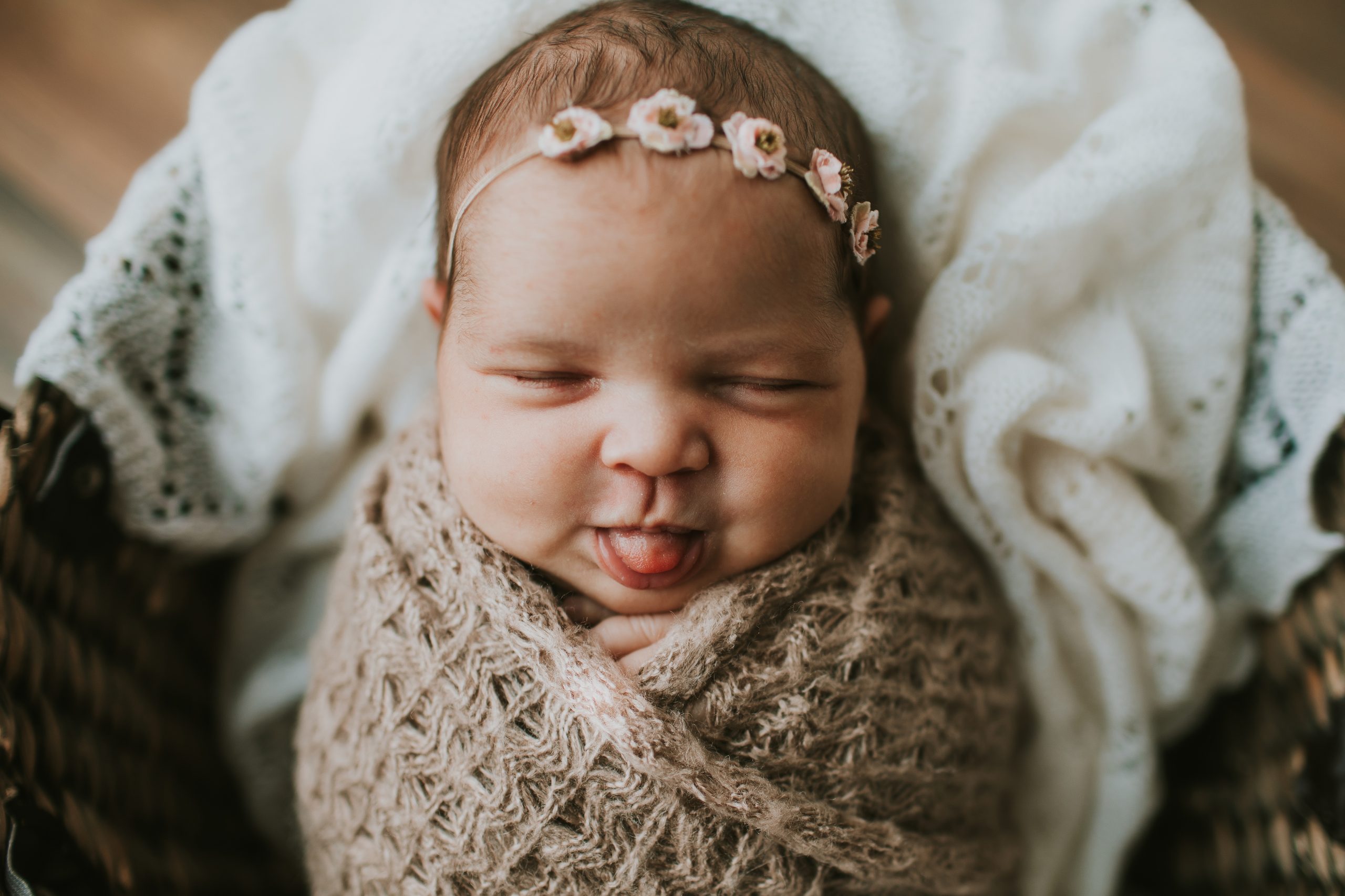 newborn sticking tongue out