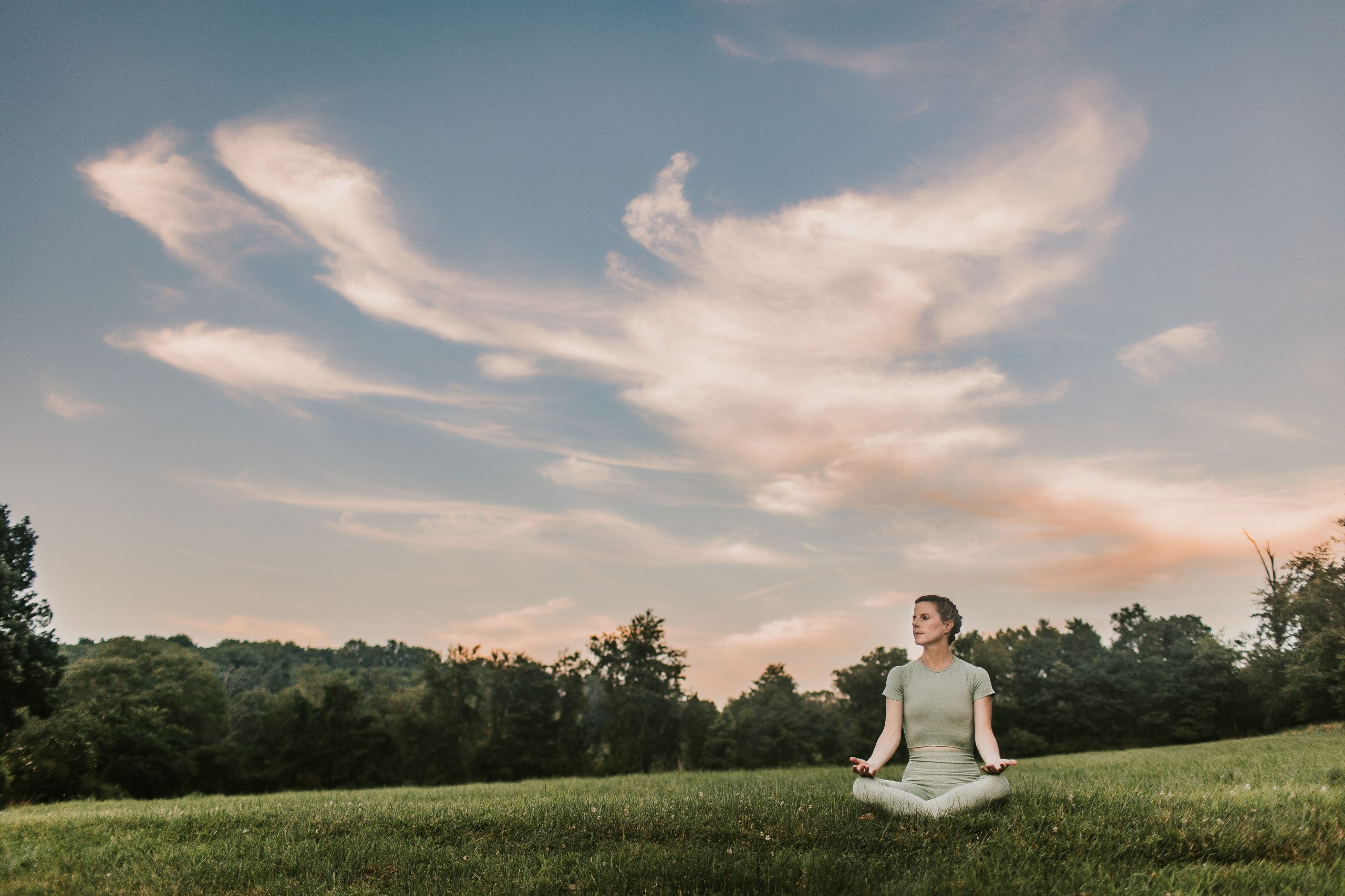 woman doing yoga meditation at sunset