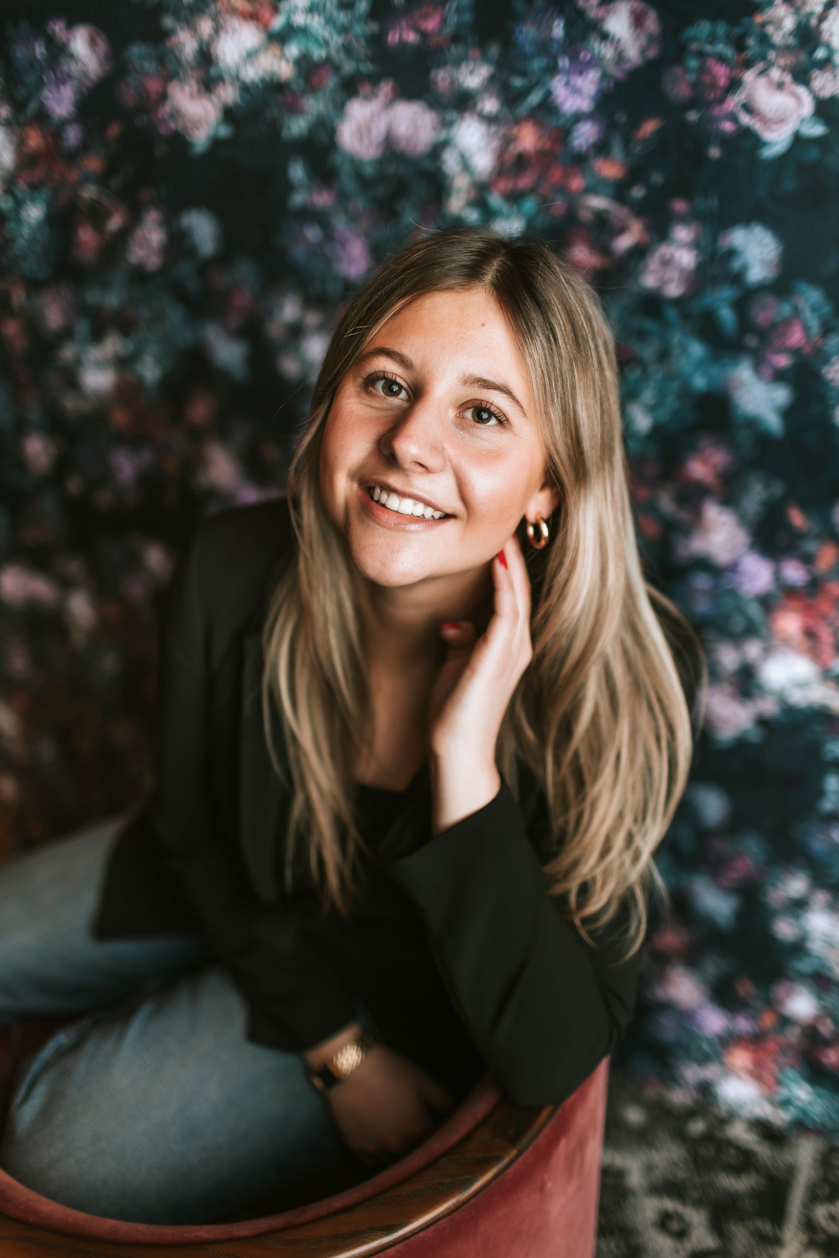 headshot of woman on floral background