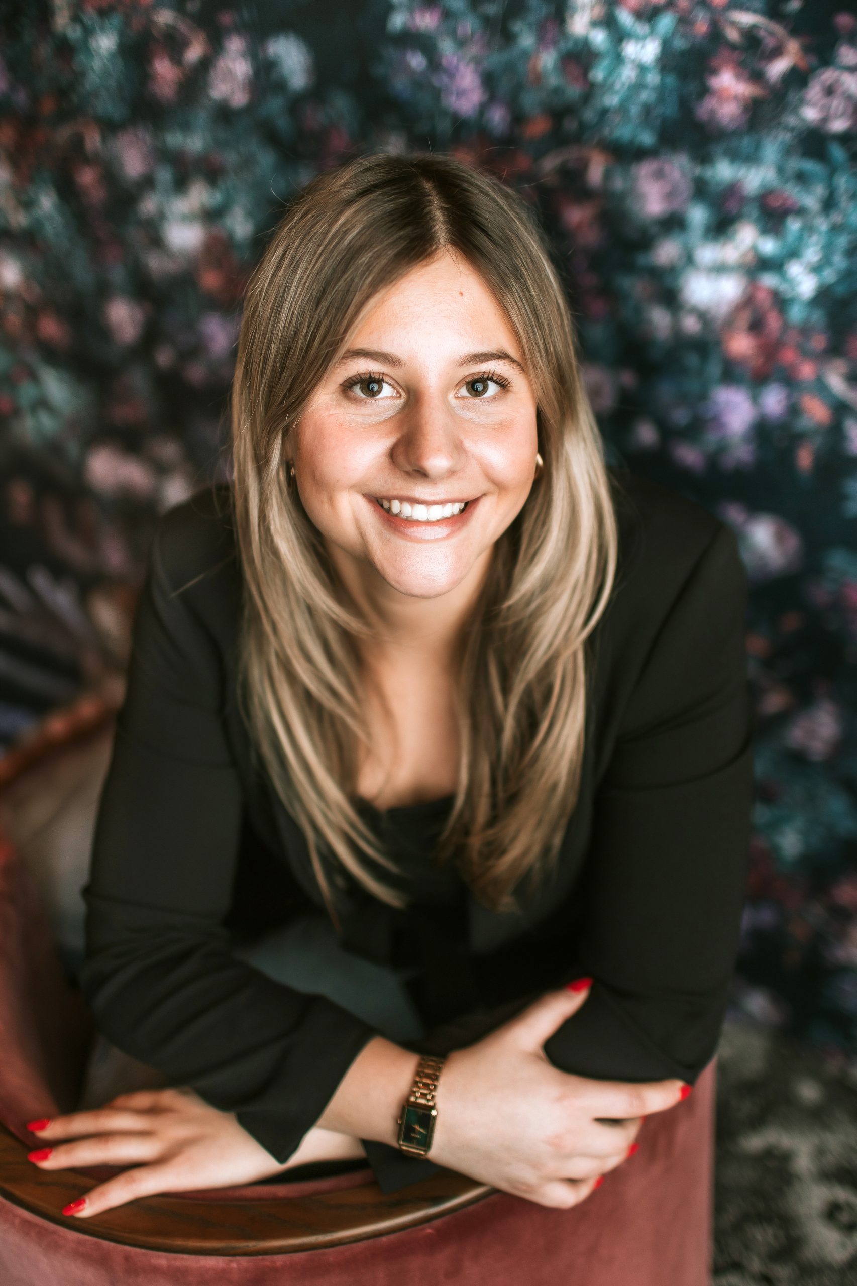 blonde woman sitting in red chair