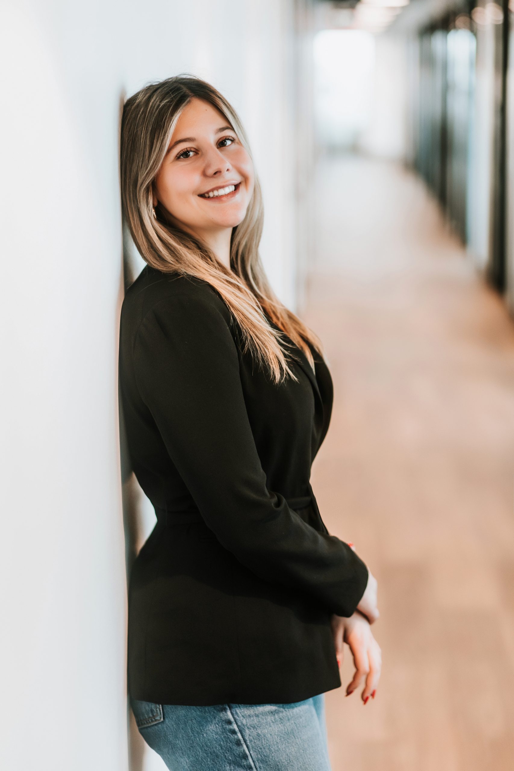 woman in long hallway leaning back