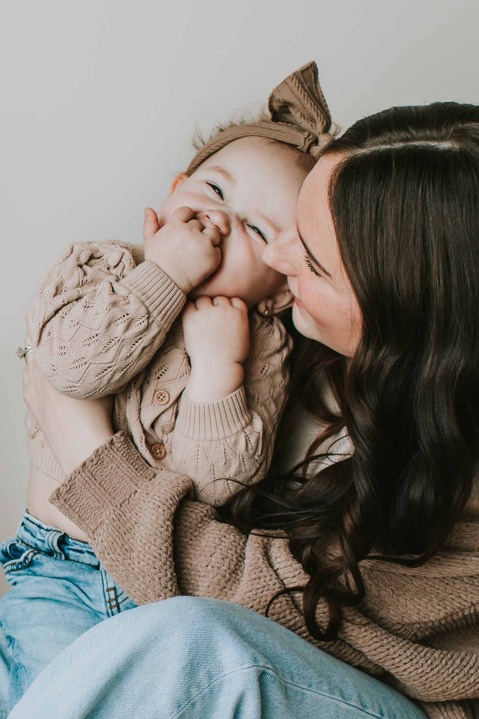mother kissing daughter on head