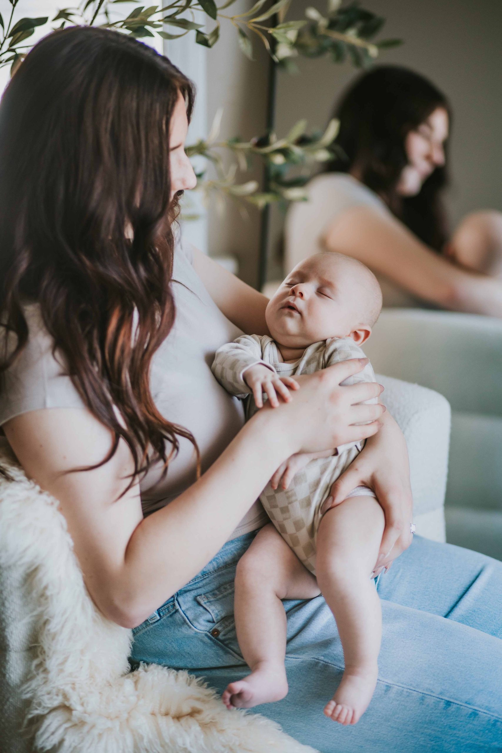 mom holding sleeping newborn boy
