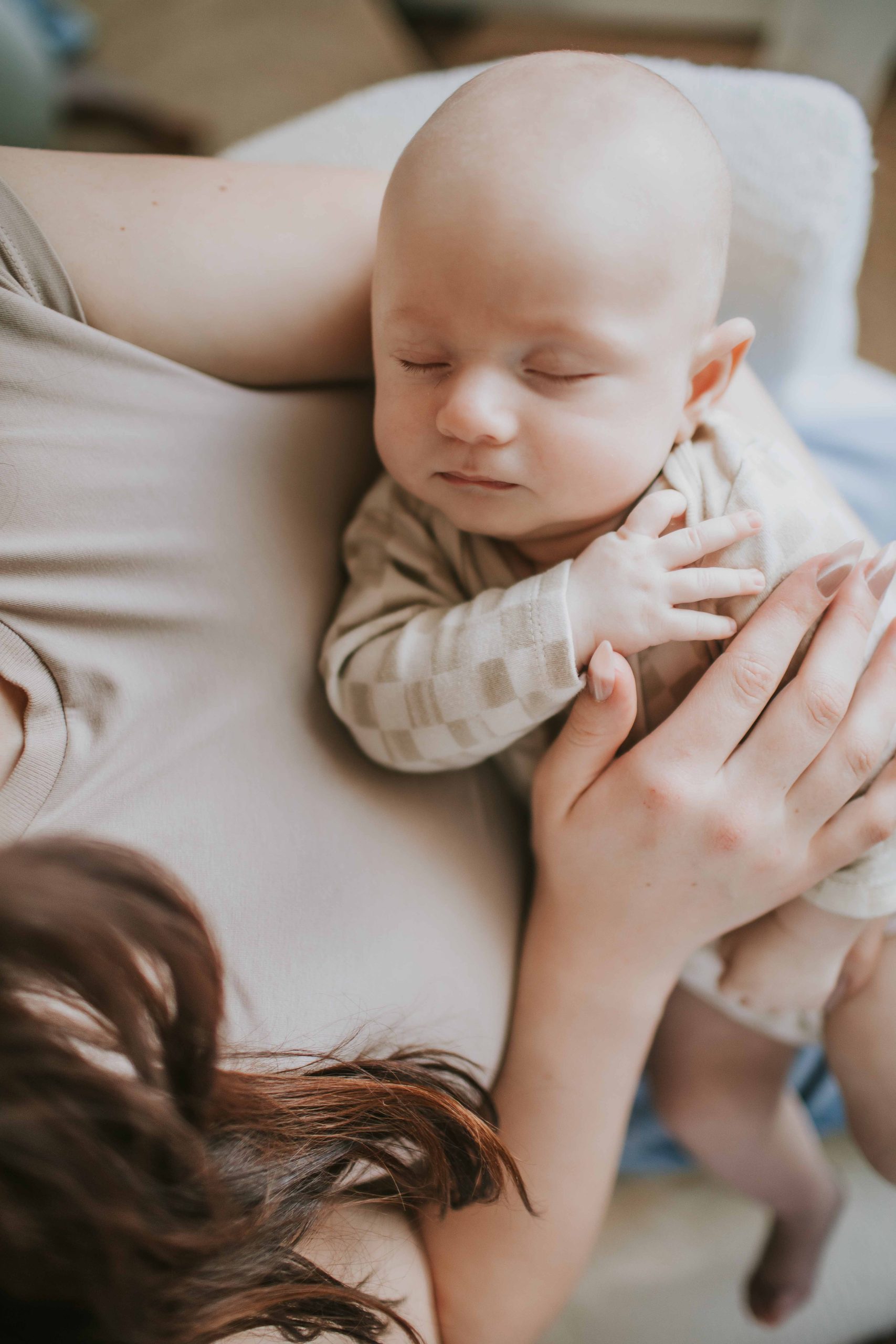 mom holding sleeping newborn