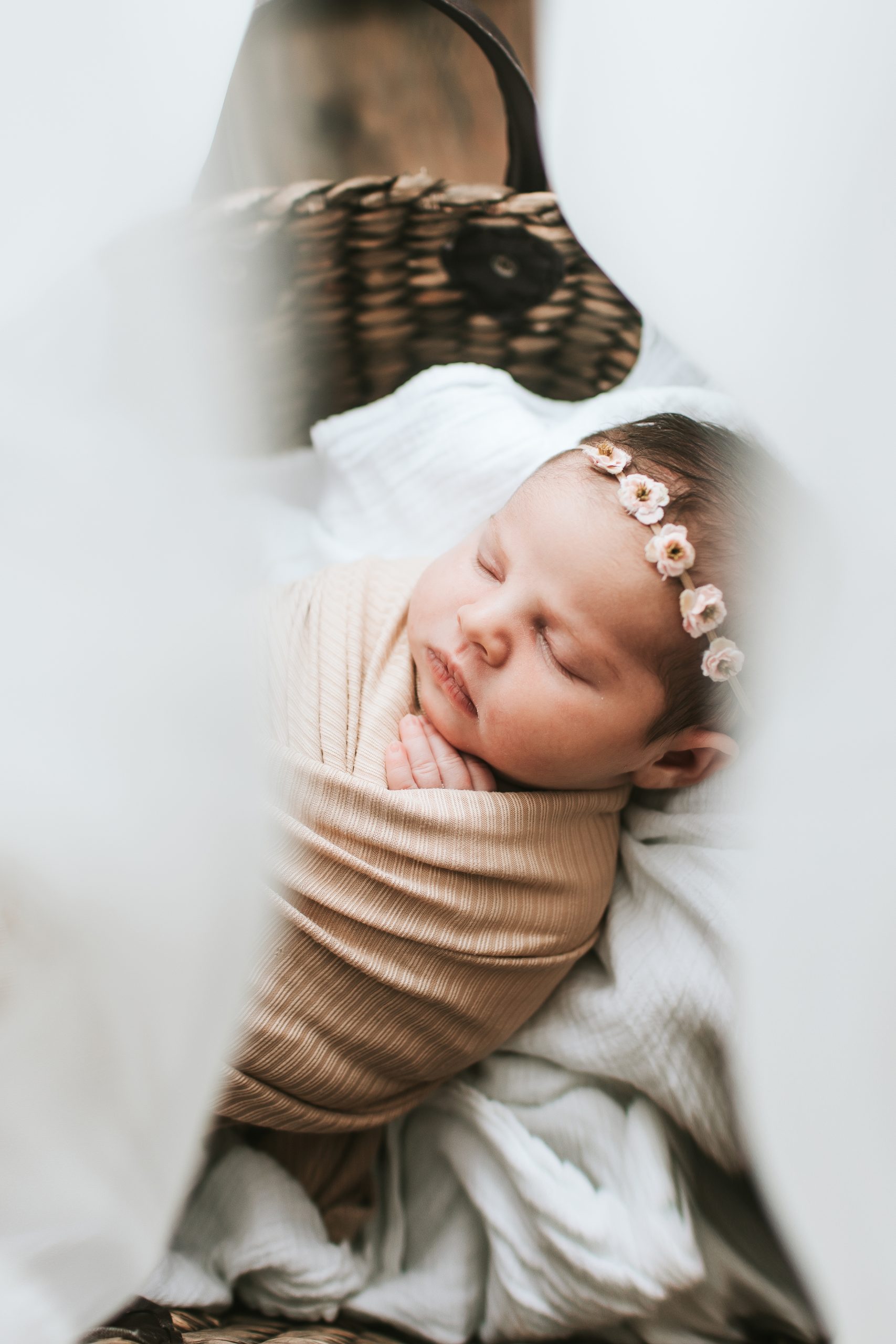 newborn sleeping in basket