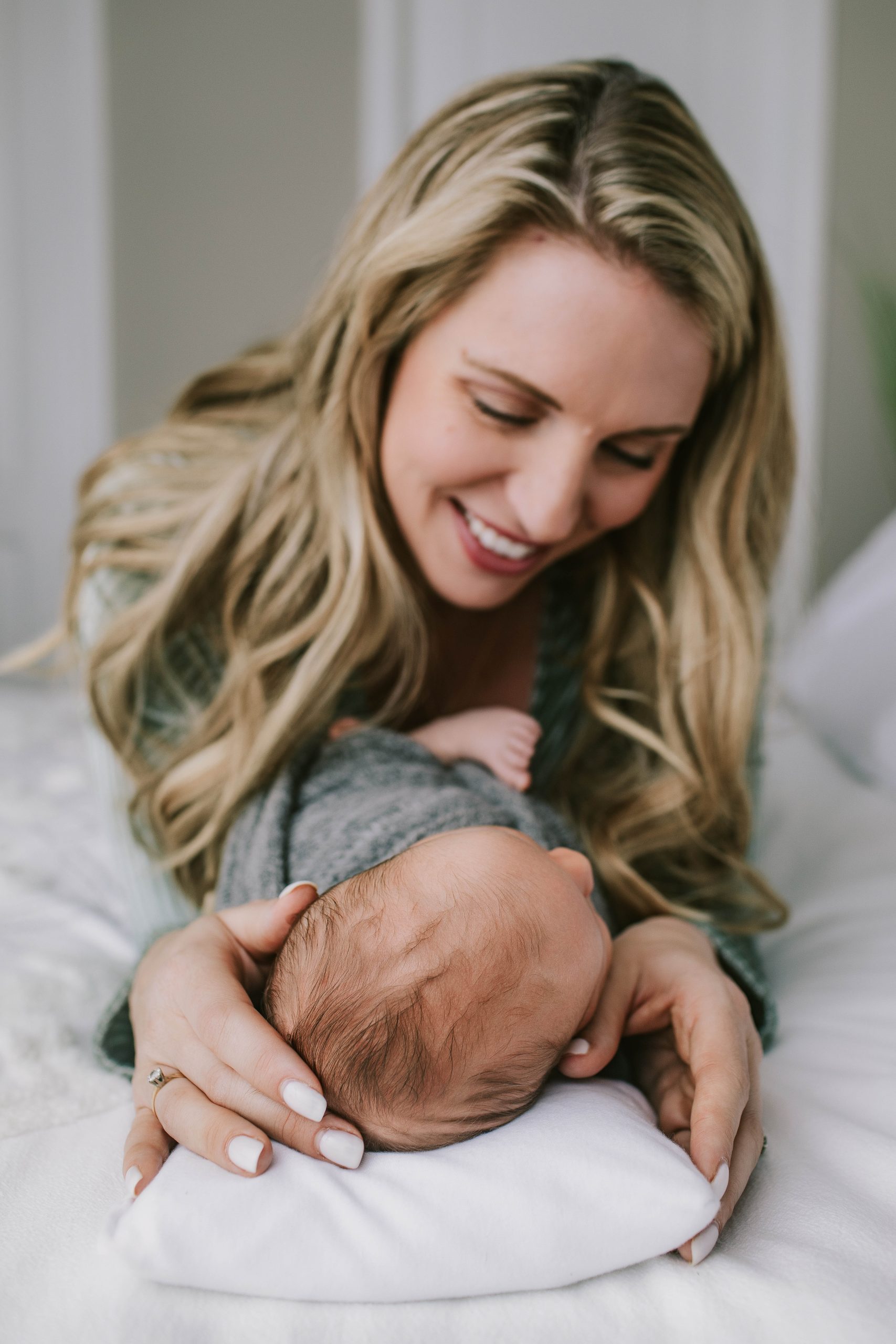 mom looking down at newborn son