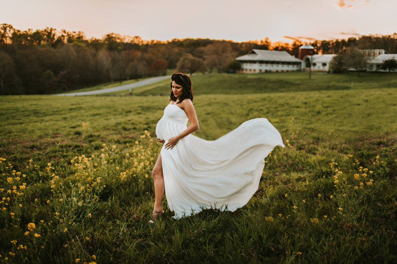 maternity portrait white flowing gown at sunset