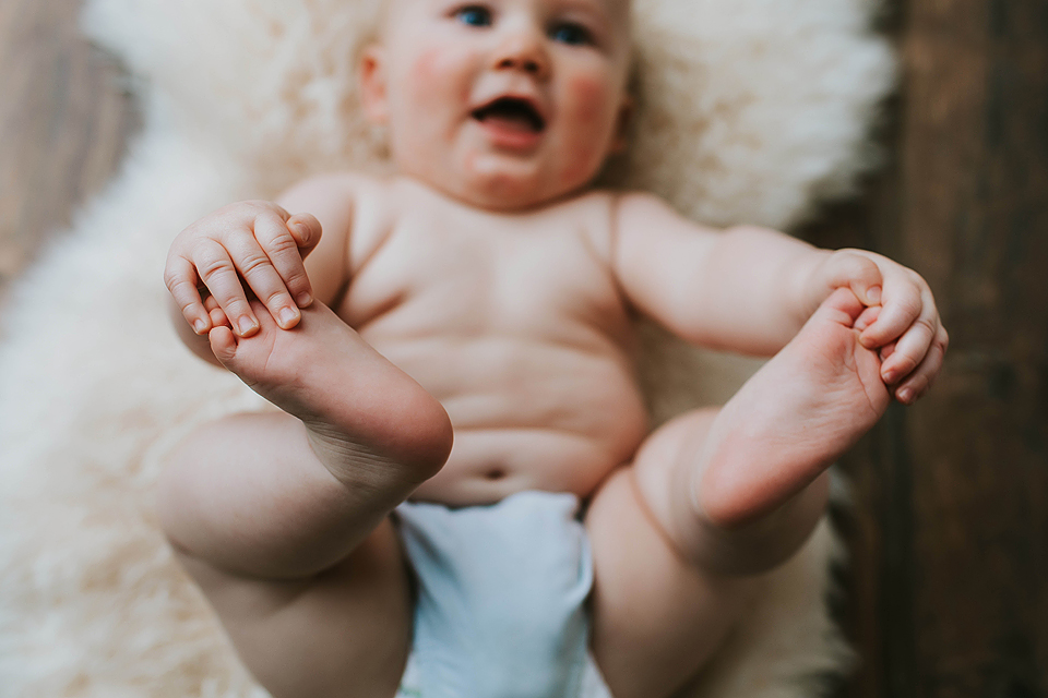 cute baby grabbing toes