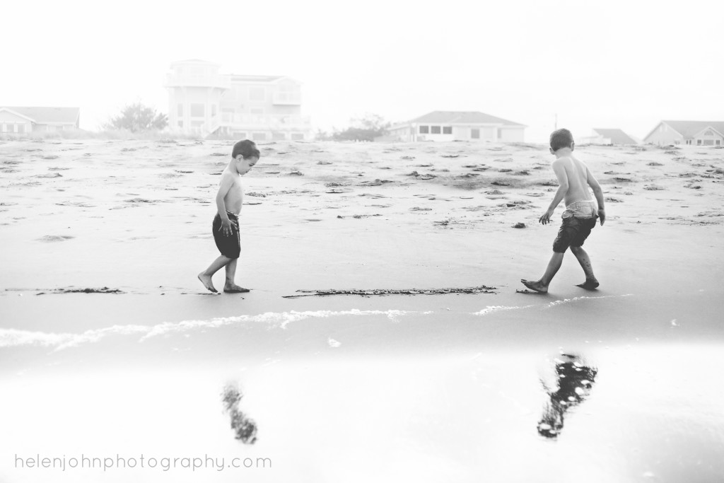 two little boys playing together on beach