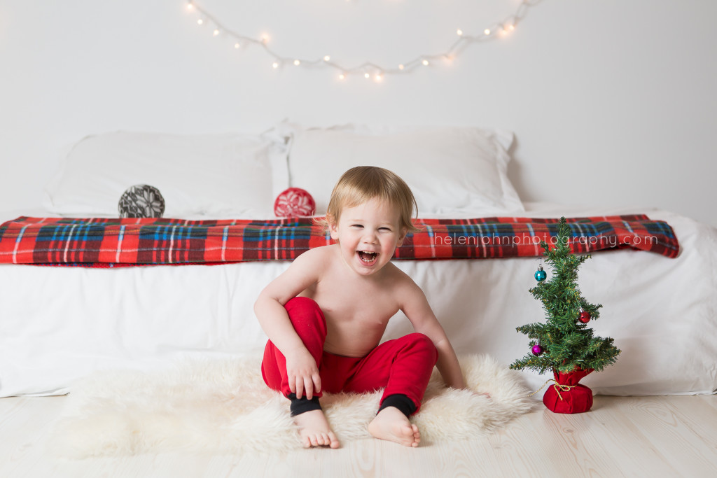 adorable baby boy in christmas PJs laughing