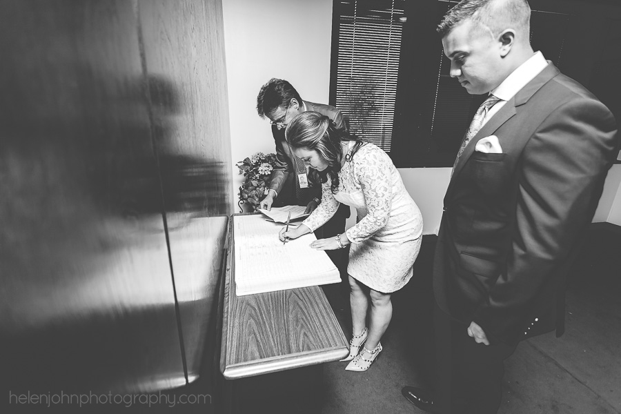 Bride and groom signing their marriage license