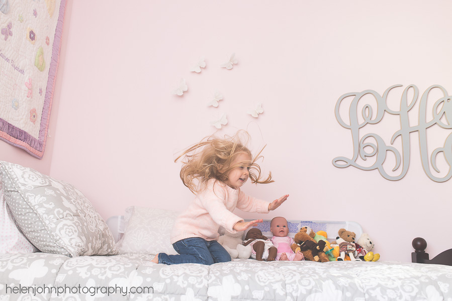 Little girl playing in her pink room