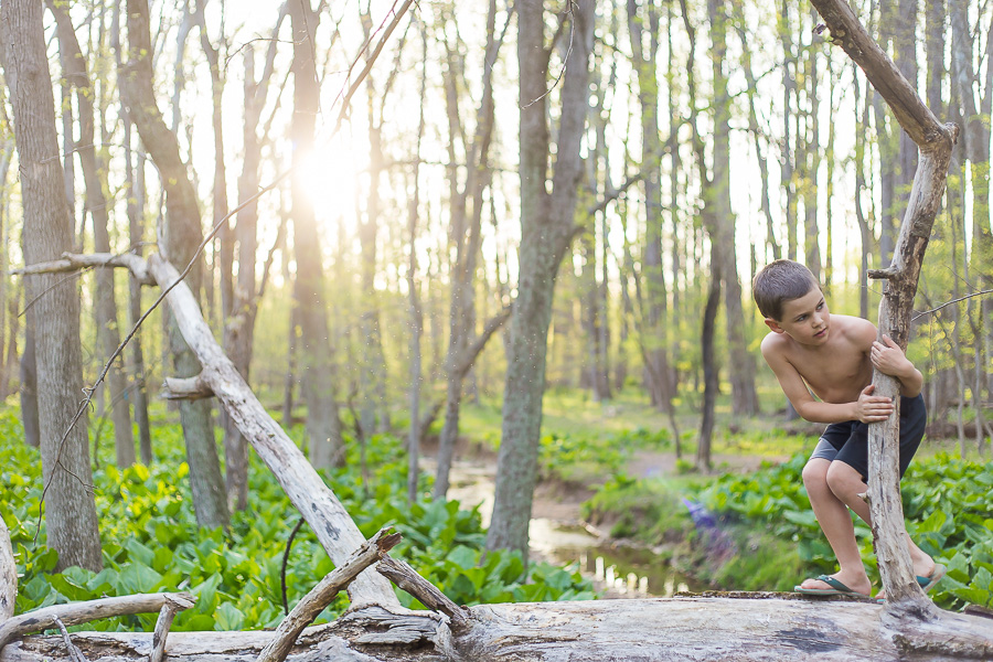 7 year old on fallen tree