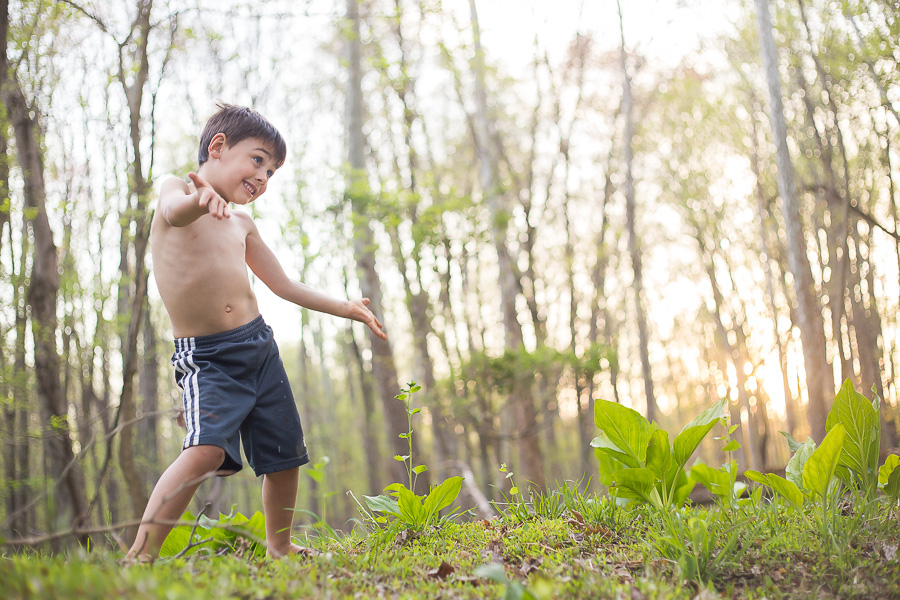 boy dancing in woods no shirt