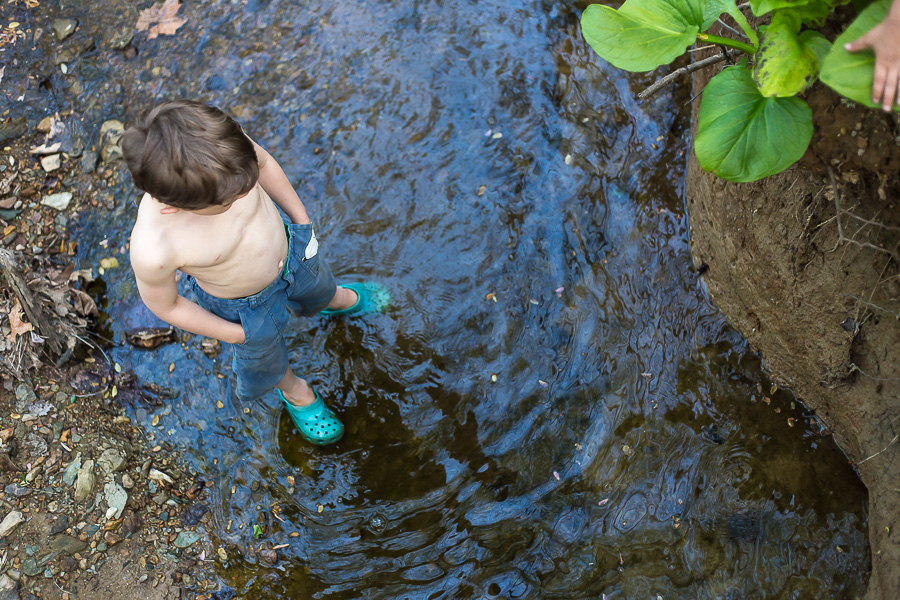 boy standing in creek