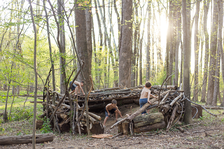 boys building fort in woods