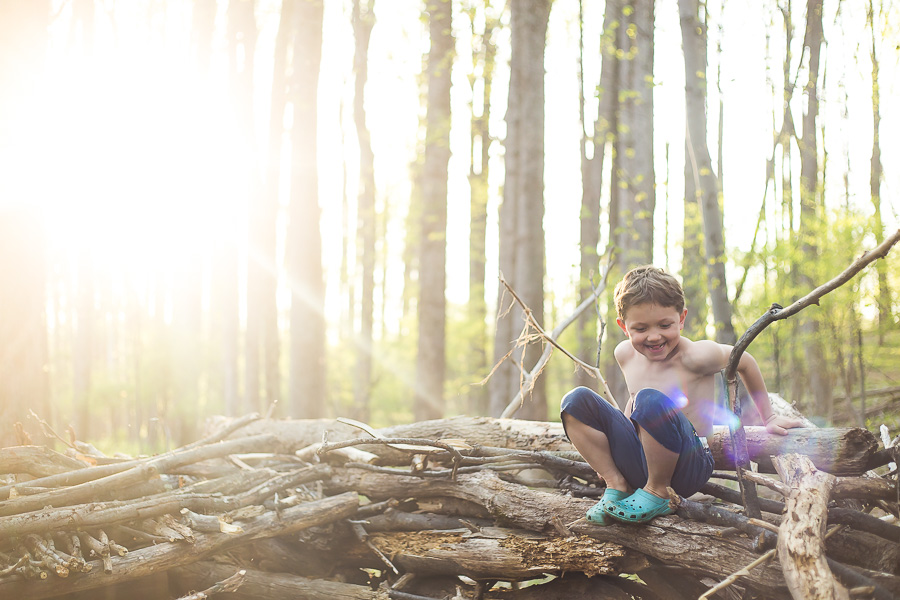 boy sitting on fort laughing