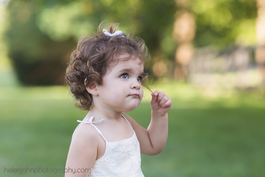 Little girl playing with her hair