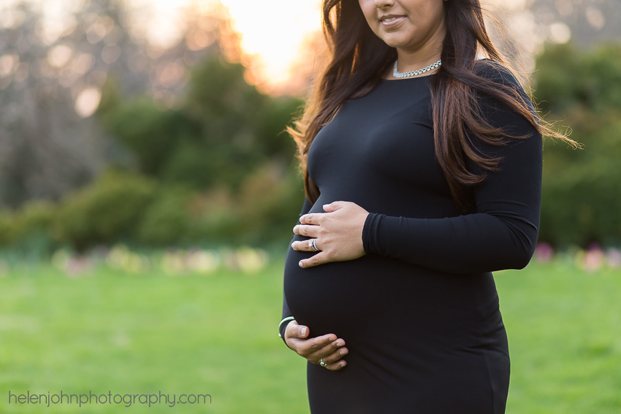 Pregnant woman standing in a black dress