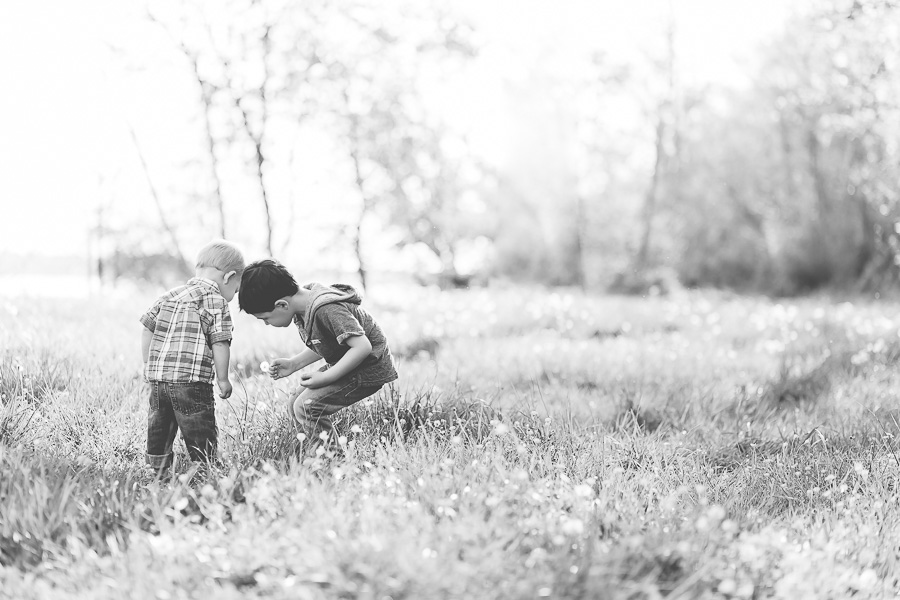 b&w two boys playing in grass