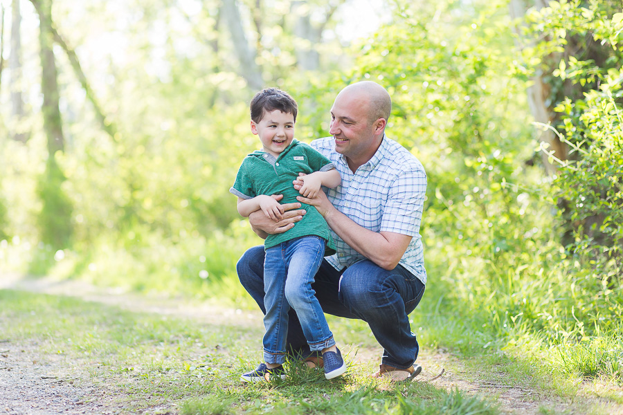 4 year old boy laughing outdors with dad