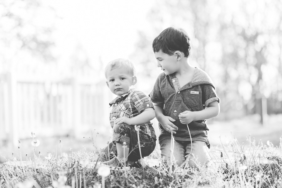 B&W little boy looking at little brother