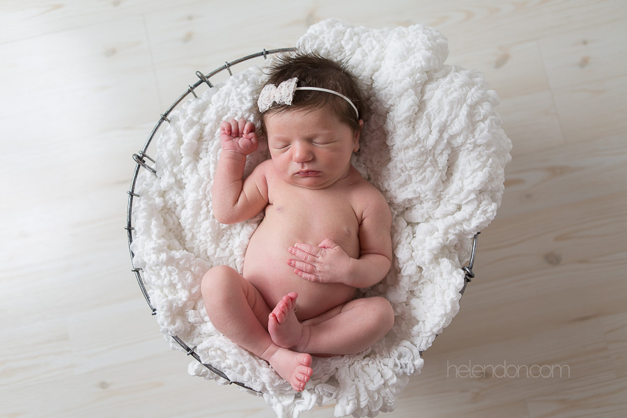 gorgeous newborn baby girl sleeping in basket