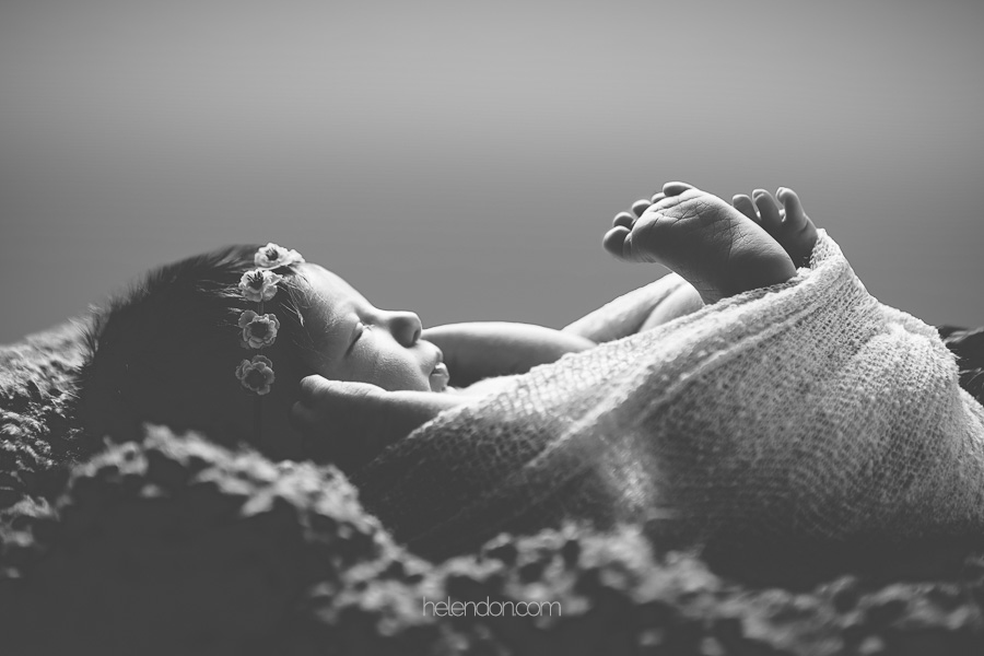 black and white photo of newborn baby girl sleeping