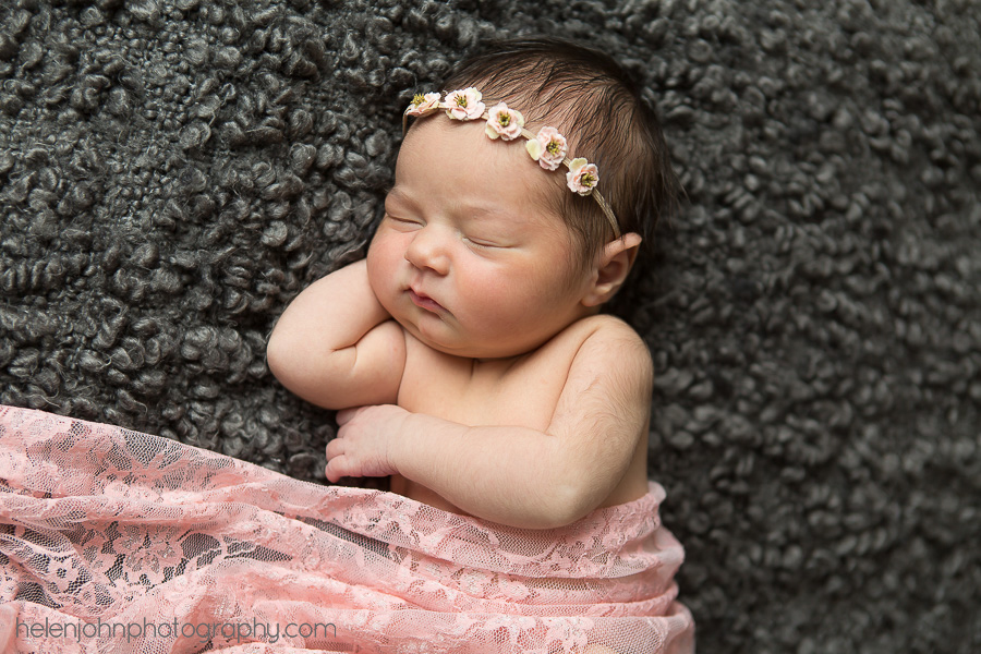Sleeping newborn baby with headband