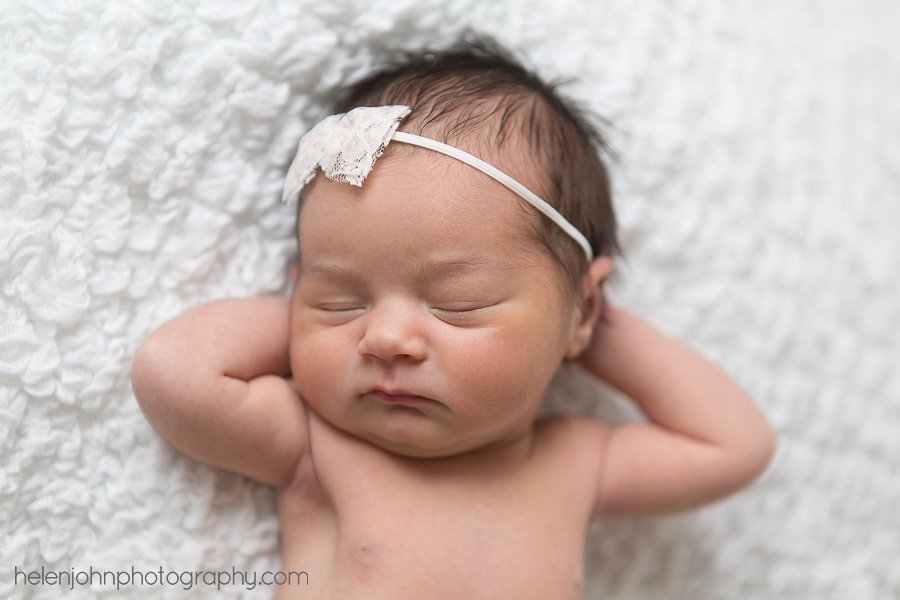 Sleeping newborn baby with bow