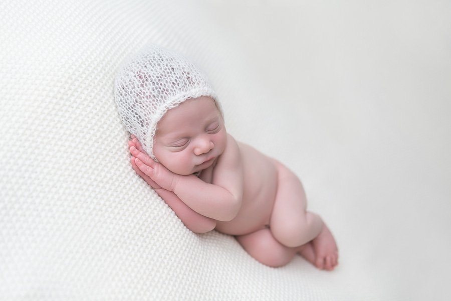 newborn boy sleeping in mohair bonnet