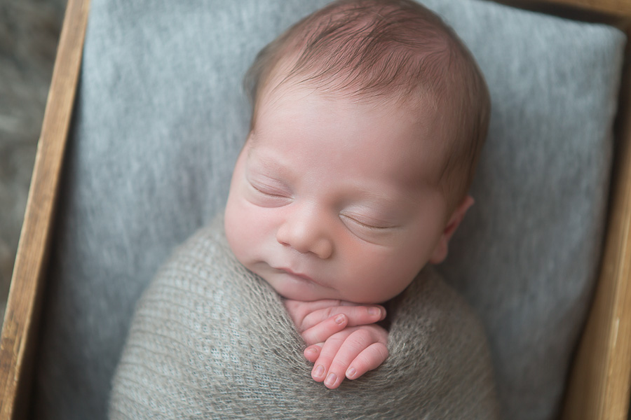 newborn boy swaddled in grey mohair