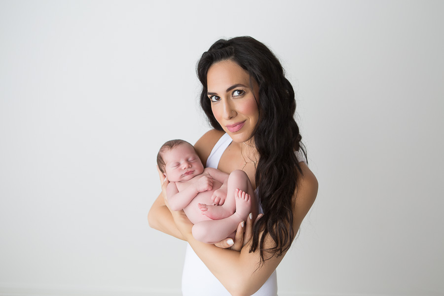 gorgeous mother holding newborn son