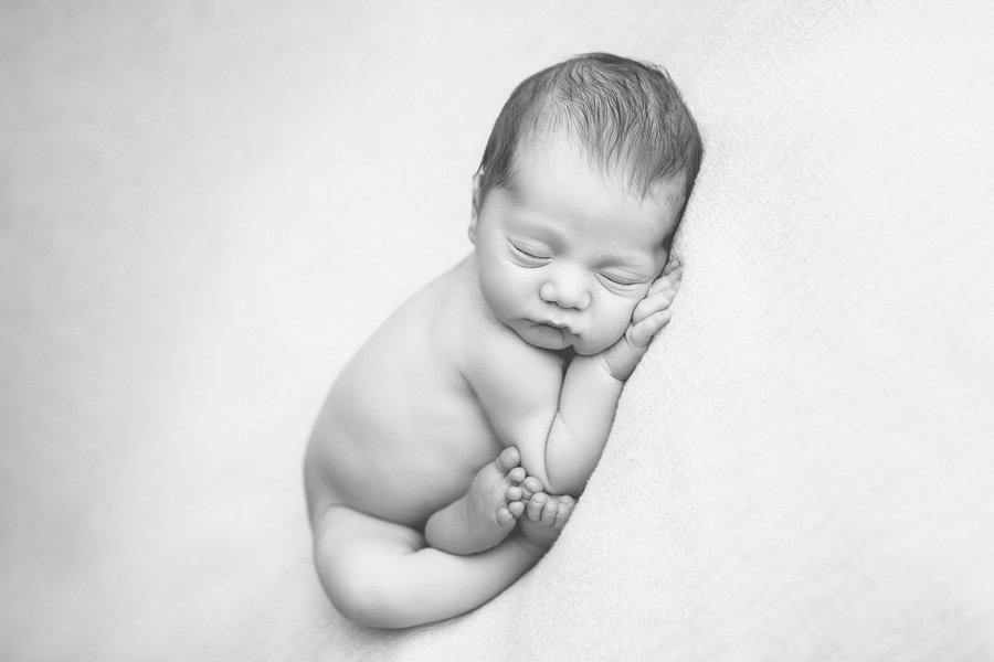 7 day old baby boy in taco pose B&W