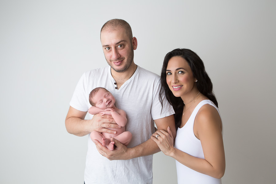 newborn smiling in first family photo