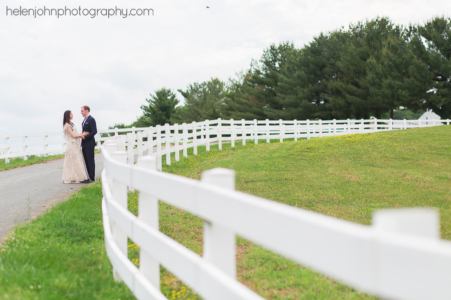 Couple standing by a fence