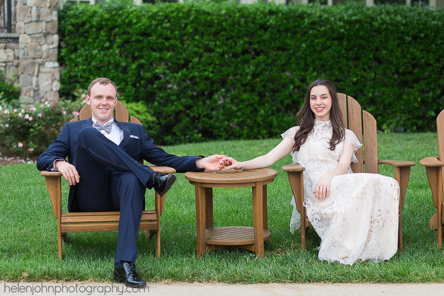 A couple sitting in a wooden chair set